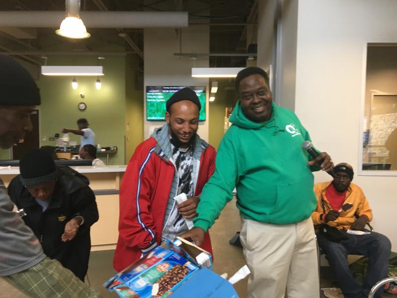 Ministering at homeless shelter giving ice cream to those who answer questions